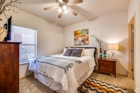 Stillwater apartment for rent - a bedroom with a bed and a ceiling fan