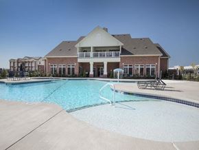Oklahoma City apartment for rent - a large swimming pool with a building in the background