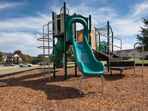 Springfield apartment for rent - a playground with a slide and chairs in a park