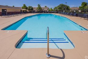Moore apartment for rent - a large swimming pool with chairs around it
