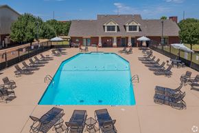 Moore apartment for rent - an aerial view of a swimming pool with chairs and a building in the background