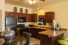 Norman apartment for rent - a kitchen with black appliances and a granite counter top
