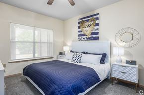 Yukon apartment for rent - a blue and white bedroom with a bed and a window