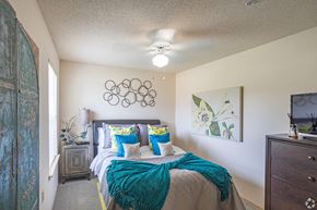 Oklahoma City apartment for rent - a bedroom with a bed and a ceiling fan