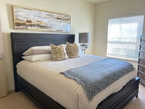 Bentonville apartment for rent - a bedroom with a bed and a painting on the wall