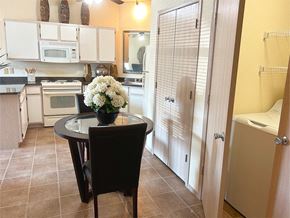 Bentonville apartment for rent - a kitchen with white appliances and a table with flowers