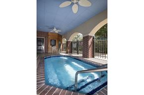 Bryant apartment for rent - a swimming pool in a house with a ceiling fan