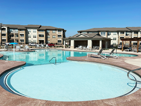 Springdale apartment for rent - A large swimming pool in front of apartment buildings.