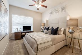 Springdale apartment for rent - A bedroom with a large bed and a ceiling fan.