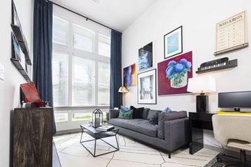 Nashville apartment for rent - A living room with a grey couch, a coffee table, and a painting on the wall.