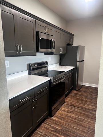 Midland apartment for rent - A kitchen with black cabinets and a white countertop.