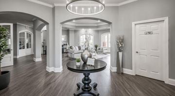Sugarland apartment for rent - A modern living room with a black table and a chandelier.