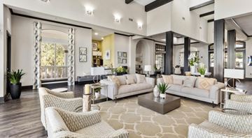 Grand Prairie apartment for rent - A spacious living room with white furniture and a patterned rug.