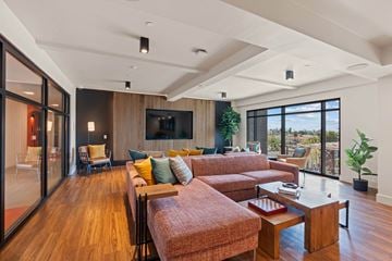 San Diego apartment for rent - A living room with a couch, a chair, a coffee table and a television.
