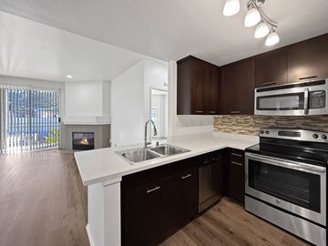San Diego apartment for rent - A modern kitchen with dark brown cabinets and stainless steel appliances.