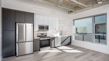 San Diego apartment for rent - A modern kitchen with a stainless steel refrigerator and microwave.