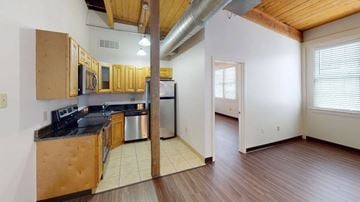 Rockland apartment for rent - A kitchen with wooden cabinets and a stainless steel refrigerator.