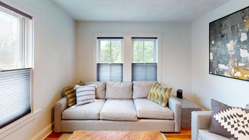 Quincy apartment for rent - A living room with a couch, pillows, and a painting on the wall.