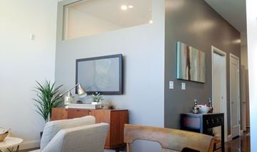 Quincy apartment for rent - A living room with a grey couch and a wooden table.