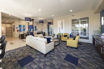 Houston apartment for rent - A spacious living room with a white couch and a yellow chair.
