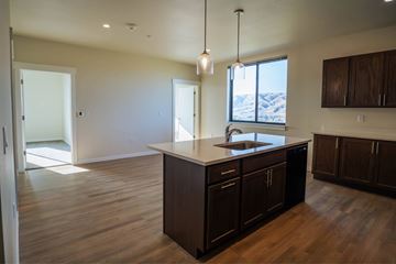 Lewiston apartment for rent - A kitchen with dark wood cabinets and a large island.