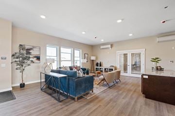 Airway Heights apartment for rent - A living room with a blue couch and a wooden floor.