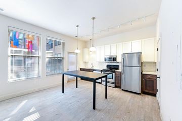 Columbus apartment for rent - A kitchen with a table and chairs in the middle of the room.