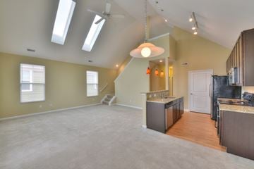 Columbus apartment for rent - A spacious kitchen and living room with a skylight and a hanging light fixture.