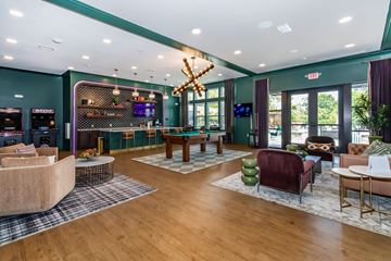 Huber Heights apartment for rent - A modern living room with a pool table and a bar area.
