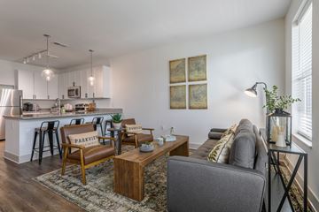 Huber Heights apartment for rent - A living room with a grey couch and a wooden coffee table.