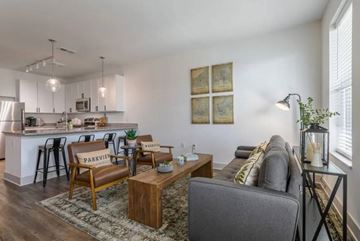 Huber Heights apartment for rent - A living room with a grey couch and a wooden coffee table.