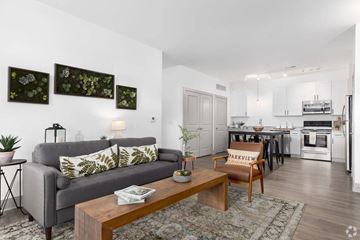 Huber Heights apartment for rent - A living room with a grey couch and a coffee table in front of it.