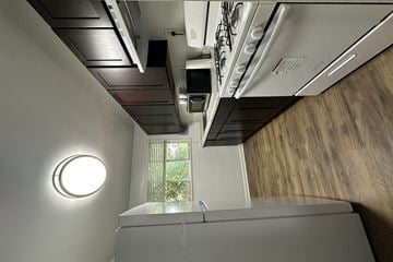 Silver Spring apartment for rent - A modern kitchen with a stainless steel oven and a round light fixture on the wall.