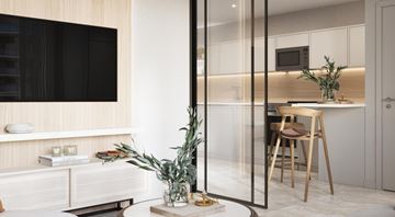 Hollywood apartment for rent - A modern kitchen with a glass partition and a dining table with chairs.