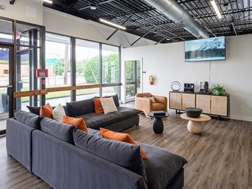 Columbia apartment for rent - A living room with a grey couch and orange pillows.