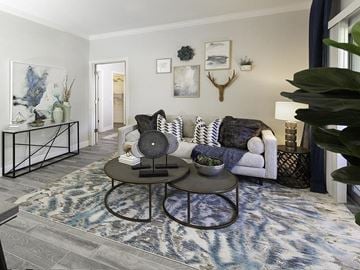 Sandy apartment for rent - A living room with a white couch and a coffee table.