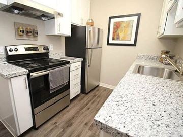 Sacramento apartment for rent - A kitchen with granite countertops and stainless steel appliances.