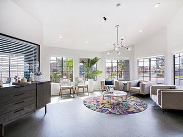 Glendale apartment for rent - A modern living room with a large rug and a chandelier.