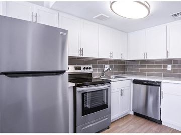 Phoenix apartment for rent - A modern kitchen with a stainless steel refrigerator and oven.