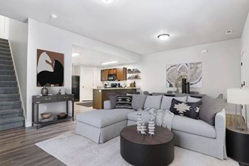 North Ogden apartment for rent - A living room with a grey couch and a coffee table.