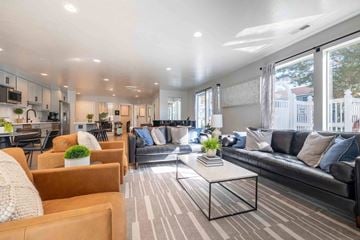 Salt Lake City apartment for rent - A modern living room with a black couch and a coffee table.