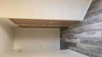 Reno apartment for rent - the living room has a wood accent wall and a white ceiling
