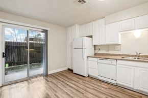 Sacramento townhouse for rent - A kitchen with white cabinets and a white fridge.
