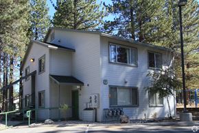 South Lake Tahoe apartment for rent - A two-story house with a white exterior and a green door.