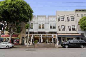 San Francisco apartment for rent - A tree in front of a building with a sign that says "Market's Local Grocery".