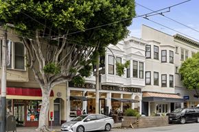 San Francisco apartment for rent - A tree in front of a building with a sign that says "Brick's Local Grocery".