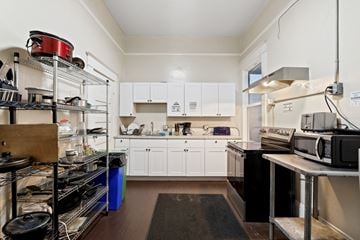 San Francisco apartment for rent - A kitchen with white cabinets and a black counter top.