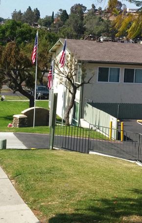 San Diego apartment for rent - a house with two flags in front of it