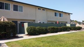 San Diego apartment for rent - a house with a fence and a lawn in front of it