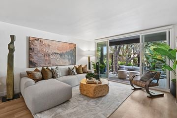 Marina Del Rey apartment for rent - A living room with a grey couch and a large painting on the wall.
